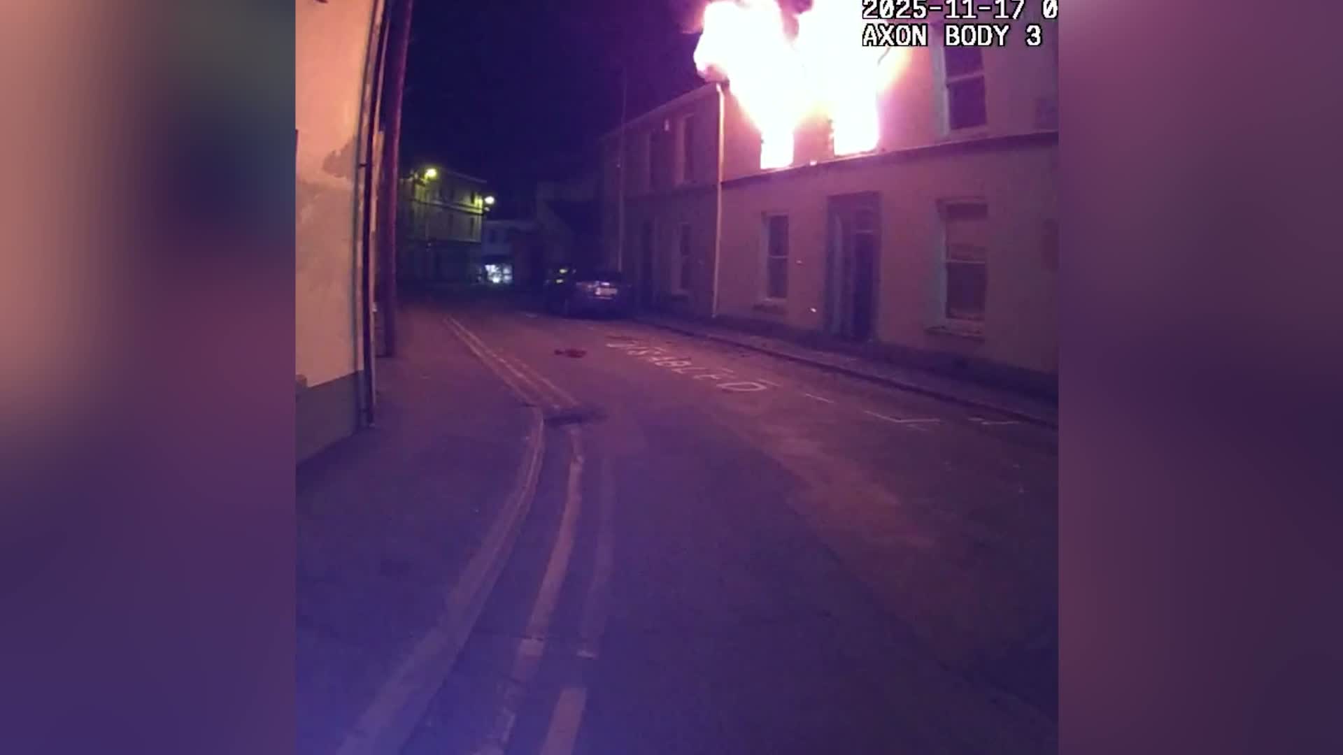 Police officers rescue sleeping woman from burning home moments before explosion